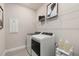 Well-equipped laundry room featuring shelving and a modern aesthetic at 1967 Spring Shower Cir, Kissimmee, FL 34744