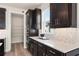 Modern kitchen with dark cabinets, quartz countertops, and stainless steel appliances at 1967 Spring Shower Cir, Kissimmee, FL 34744