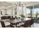 Modern dining room with large mirrors and view to backyard at 1967 Spring Shower Cir, Kissimmee, FL 34744
