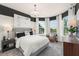 Main bedroom with large windows and seating area at 1967 Spring Shower Cir, Kissimmee, FL 34744