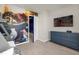 Bedroom with a mural, TV, and dresser; door to another room is visible at 3954 Lana Ave, Davenport, FL 33897