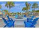 Round fire pit with blue Adirondack chairs at 3954 Lana Ave, Davenport, FL 33897