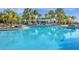 Large resort-style pool with palm trees and lounge chairs at 3954 Lana Ave, Davenport, FL 33897
