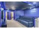 Spacious home theater with plush seating and blue accent lighting at 3954 Lana Ave, Davenport, FL 33897