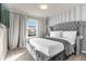 Elegant bedroom with gray upholstered bed and large window at 3954 Lana Ave, Davenport, FL 33897