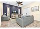 Bright living room with gray sofas, a large TV, and French doors at 2984 Salted Rim Rd, Kissimmee, FL 34747