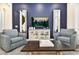 Living room featuring two armchairs, a coffee table, and a large TV at 2984 Salted Rim Rd, Kissimmee, FL 34747