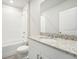 Clean bathroom featuring a granite countertop, white cabinets and a shower/tub combo at 1705 Forest Run Ln, Auburndale, FL 33823