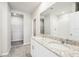 Double vanity bathroom with granite countertop and large mirror at 1705 Forest Run Ln, Auburndale, FL 33823