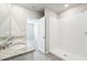 Bathroom with double vanity, shower, and access to bedroom at 1705 Forest Run Ln, Auburndale, FL 33823
