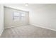 Well-lit bedroom with grey carpet and two large windows at 1705 Forest Run Ln, Auburndale, FL 33823