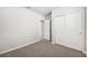 Bright bedroom with grey carpet, double door closet, and an additional door at 1705 Forest Run Ln, Auburndale, FL 33823