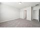 Spacious bedroom with grey carpet and access to bathroom at 1705 Forest Run Ln, Auburndale, FL 33823