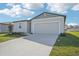 One-story house with a two-car garage and well-maintained lawn at 1705 Forest Run Ln, Auburndale, FL 33823