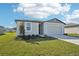 Single-story home with a two-car garage and a front yard at 1705 Forest Run Ln, Auburndale, FL 33823