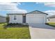 One-story home with a two-car garage and landscaped lawn at 1705 Forest Run Ln, Auburndale, FL 33823