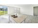 Modern kitchen with island, stainless steel appliances, and backyard view at 1705 Forest Run Ln, Auburndale, FL 33823