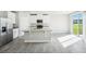 Modern kitchen with island, stainless steel appliances, and patio access at 1705 Forest Run Ln, Auburndale, FL 33823