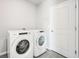 Laundry room with Whirlpool washer and dryer, and tiled floor at 1705 Forest Run Ln, Auburndale, FL 33823