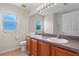 Bathroom with double sinks and wood cabinets at 2855 Gopherwood Way, Clermont, FL 34711