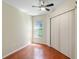 Well-lit bedroom with hardwood floors and a ceiling fan at 2855 Gopherwood Way, Clermont, FL 34711