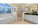 Bathroom featuring a shower, tub, and double vanity at 2855 Gopherwood Way, Clermont, FL 34711