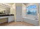 Bathroom with soaking tub, shower, and double vanity at 2855 Gopherwood Way, Clermont, FL 34711