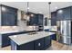 Spacious kitchen with island, stainless steel appliances, and blue cabinetry at 2149 Divot Dr, Daytona Beach, FL 32124