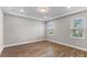 Spacious bedroom with wood-look tile floors and two windows at 2149 Divot Dr, Daytona Beach, FL 32124