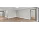 Bright living room with wood-look tile floors and access to hallway at 2149 Divot Dr, Daytona Beach, FL 32124