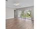 Spacious living area featuring hardwood floors and access to patio at 2149 Divot Dr, Daytona Beach, FL 32124