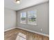 Bright bedroom with wood-look floors and two windows at 2149 Divot Dr, Daytona Beach, FL 32124