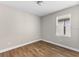 Small bedroom with wood-look floors and one window at 2149 Divot Dr, Daytona Beach, FL 32124