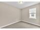 Spacious bedroom with neutral walls, carpet flooring, and a window with blinds at 3116 Legends Preserve Dr, Daytona Beach, FL 32124