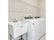 Laundry room with washer, dryer, utility sink, and overhead shelving at 3116 Legends Preserve Dr, Daytona Beach, FL 32124
