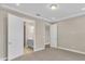 Bright bedroom with neutral walls and carpet, showing access to bathroom and closet at 3116 Legends Preserve Dr, Daytona Beach, FL 32124