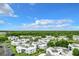 An aerial shot showcasing a large community of residential buildings, surrounded by greenery and parking areas at 3937 Atrium Dr # 5, Orlando, FL 32822