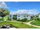 Exterior of condo building with pond and walkway at 3937 Atrium Dr # 5, Orlando, FL 32822
