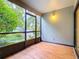 Screened patio with wood-look flooring and access to exterior at 3937 Atrium Dr # 5, Orlando, FL 32822
