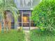 Exterior view of condo building with lush landscaping at 3937 Atrium Dr # 5, Orlando, FL 32822