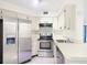 White cabinets, stainless steel appliances, and a corner sink at 3937 Atrium Dr # 5, Orlando, FL 32822
