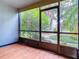 Screened porch with wood-look flooring and access to a garden at 3937 Atrium Dr # 5, Orlando, FL 32822
