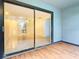Bright screened porch with wood-look flooring and sliding glass doors at 3937 Atrium Dr # 5, Orlando, FL 32822