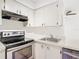 Kitchen features white cabinets and stainless steel appliances at 3937 Atrium Dr # 5, Orlando, FL 32822