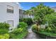 Exterior of condo building showcasing landscaping and walkway at 3937 Atrium Dr # 5, Orlando, FL 32822