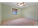 Spacious bedroom with ceiling fan and window at 8 Escondido Cir # 78, Altamonte Springs, FL 32701