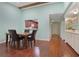 Open dining area with hardwood floors, kitchen pass-through, and bar area at 8 Escondido Cir # 78, Altamonte Springs, FL 32701