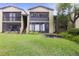 Two-story condo building with green lawn and trees at 8 Escondido Cir # 78, Altamonte Springs, FL 32701