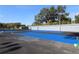Blue tennis court with surrounding fencing at 8 Escondido Cir # 78, Altamonte Springs, FL 32701