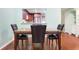Granite-topped dining table with four chairs in this open area at 8 Escondido Cir # 78, Altamonte Springs, FL 32701